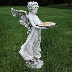 an angel holding a plate of food in the grass