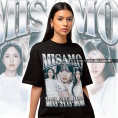 a woman standing in front of an advertisement for miss m's moms t - shirt