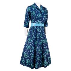 1950s Navy Blue floral printed rayon twill custom made day dress with inteiro taffeta & tulle petticoat. The Face oth edress is decorated with large rhinestoned centered buttons, an enlarged pointed collar, elbow-length sleeves that cuff and are finished with matching buttons. The print features a teal, blue and shades of green floral motif. This garment was photographed with an additional petticoat and belt to give it the era-appropriate silhouette and is not included with the purchase of the d Tulle Petticoat, Floral Printed Dress, Silk Cocktail Dress, 1950s Dress, Blue Silk, Day Dress, Elbow Length Sleeve, Printed Dress, Petticoat