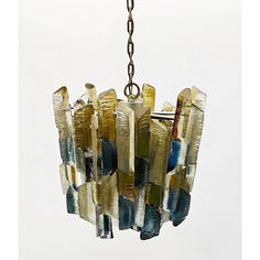 a chandelier hanging from a chain with multiple pieces of glass in the middle