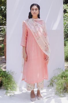 Old rose pink long kurta with detailing of pintucks over yoke. Comes with rose jaal hand block printed cotton pants and dupatta with stripes detailing. 
Component: 3
Block Print
Sleeve Length: Three Quarter
Fabric: Kurta: Handwoven Chanderi, Pants: Cotton, Dupatta: Chanderi
Color: Pink
Pintuck kurta
Striped border dupatta - Aza Fashions Pink Kurti, Pink Kurta, Old Rose, White Hand, Printed Sleeves, Pin Tucks, Cotton Pants, Ethnic Wear, Rose Print