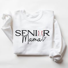 This Senior Baseball Mama Sweatshirt is perfect to support your High School Senior Baseball player on game day! Welcome to my store! *Please Note- this sweatshirt runs true to the size guide provided. If you would like it oversized, please size up* Ideal for any situation, a unisex heavy blend crewneck sweatshirt is pure comfort. These garments are made from polyester and cotton. This combination helps designs come out looking fresh and beautiful. The collar is ribbed knit, so it retains its sha Pre-shrunk Crew Neck Sweatshirt For School Spirit, Long Sleeve T-shirt For Baseball Game Day, White Long Sleeve Tops For Fan Gear, Team Spirit Sweatshirt With Logo Print For Game Day, Team Spirit Logo Print Sweatshirt For Game Day, Senior Baseball Mom Shirts, Team Spirit Sweatshirt With Logo Print For Fans, College Fan Apparel Sweatshirt With Logo Print, Collegiate Team-colored Sweatshirt With Logo