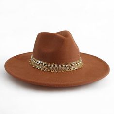 Dazzle in Nashville with this stunning vegan suede rancher hat, handcrafted with 5 rows of sparkling jewelry and trim. This statement hat is perfect for adding a touch of Western flair to any outfit, whether you're dressing up for a night out on the town or keeping it casual for a day of exploring. Made with high-quality vegan suede, this hat is both stylish and comfortable. The wide brim provides sun protection, while the adjustable sweatband ensures a perfect fit.       This hat is sure to turn heads and make you feel like a star. Order yours today!       Details:       + Color: Tan Brown    + Brim size: 3 inches    + Jewelry and trim: A mix of beads, chains, and trims    + Care: Spot clean    + One size fits most women 22-23 " or ( 56-57cm)    it has adjustable straps to to ensure a com Flat Brim Cowboy Hat, Nashville Cowgirl, Cowgirl Hats Western, Statement Hat, Hat Western, Sparkling Jewelry, Rancher Hat, Chapeau Cowboy, Hat Custom