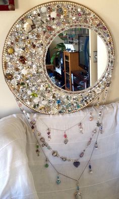 there is a mirror that has many different necklaces on it