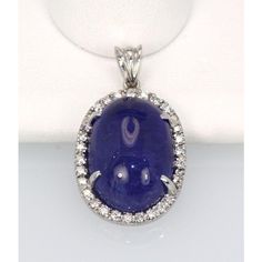 This is part of Chairish’s Fine Jewelry assortment.  WEIGHT: 7.8 grams MAIN STONE: Tanzanite, 20 cts OTHER STONES: Diamonds, .50 ct, VVS-VSI clarity, G-H color METAL: 18k white gold  This Tanzanite Cabochon Pendant with a Diamond surround is done in 18K White Gold and is brand new and never been worn. This tanzanite is a gorgeous shade of blue with nice metrics and it is large 21 Carats with a Diamond Border of .50 Carats of Diamonds. This pendant is high domed just like the matching ring and as Luxury Diamond Gemstones With Cabochon Cut, Luxury Diamond Cabochon Gemstones, Oval Diamond Gemstones For Formal Occasions, Formal Oval Diamond Gemstones, Luxury Sapphire Gemstones With Round Cut, Oval Gemstones With Prong Setting For Formal Occasions, Oval Diamond Cabochons With Polished Finish, Luxury Diamond Cabochons For Wedding, Luxury Oval Cabochon Diamond Gemstones