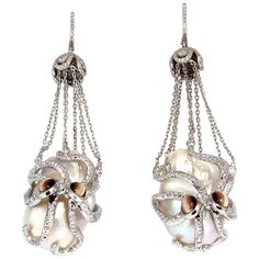 Octopus catch / dangle earrings. 30mm & 29mm natural Freshwater Baroque pearls. GIA Certified White with slight pink overtone. clean clarity, No pits or naturals. 2.00cts of round natural color diamonds: G-color Vs-2 clarity. 2.00ct (4) Natural Cats-Eye Chrysoberyl on eyes. 14kt. white gold 50 grams. Earrings measure 2.9 inch long $27,000 Appraisal Certificate to accompany Luxury Oval Pearl Earrings, Luxury Drop Pearl Earrings, Luxury Drop Pearl Earrings For Evening, Luxury Evening Drop Pearl Earrings, Luxury Briolette Pearl Earrings, Luxury Oval Pearl Drop Earrings, Luxury Pearl White Dangle Pearl Earrings, Exquisite White Dangle Pearl Earrings, Luxury Dangle Pearl Earrings