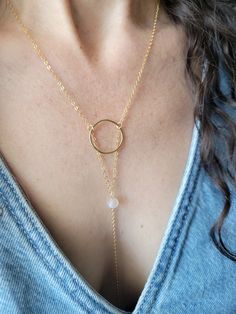 The Moon Beam Necklace features a beautiful petite Moonstone Gem. It is a lariat style necklace and is dainty and feminine! You can wear it so it is tucked into your top like shown or worn out. The circle is hammered and the length of the drop from the top of the circle down to the bottom on the chain is about 5 in. The length shown in the pictures is at a 16 in chain length. Each piece is handmade and may vary slightly as well as the stones as they are natural. Thank you! Adjustable Dainty Lariat Necklace For Layering, Adjustable Delicate Chain Lariat Necklace, Adjustable Dainty Round Lariat Necklace, Adjustable Round Lariat Necklace In Dainty Style, Adjustable Round Lariat Necklace With Delicate Chain, Dainty Circle Adjustable Necklace, Adjustable Round Minimalist Lariat Necklace, Adjustable Minimalist Lariat Necklace, Dainty Round Lariat Necklace With Delicate Chain