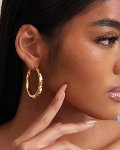 The ‘Noelle’ hoop earrings have an organic and freeform shape. There is a rounded spike pattern that goes around the outer edge of the earrings to give off a funky vibe. At the same time, the earrings look elegant and luxurious due to the high polish finish and shine. The earrings are constructed in 18k yellow gold or white gold plated over sterling silver metal. Each piece is hand polished and inspected to assure a high-quality finish. Closure: Hoop Stamp Approx. Measurement: Outer Length: 1.7 inches Outer Width: 7 inches Silver weight: Approx. 0.26 oz Bamboo Hoop Earrings, Chunky Hoop Earrings, Earring Sale, Shop Earrings, Post Earrings, Jewelry Pieces, Metallic Silver, 18k Gold, Gold Plate