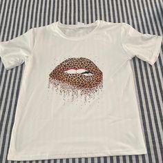 New Without Tags Lips T-Shirt. Fun Leopard Print. 100% Polyester, 18 Inches Pit To Pit Does Have Some Stretch. Trendy Leopard Print Graphic T-shirt, Casual Stretch Tiger Print Tops, Leopard Print Graphic T-shirt For Summer, Summer Leopard Print Graphic T-shirt, Trendy Leopard Print Top With Lettering, Trendy Leopard Print T-shirt With Crew Neck, Leopard Print Top With Letter Print For Summer, Trendy Leopard Print Top With Letter Details, Casual Summer T-shirt With Tiger Print