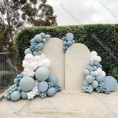 an arch decorated with blue and white balloons