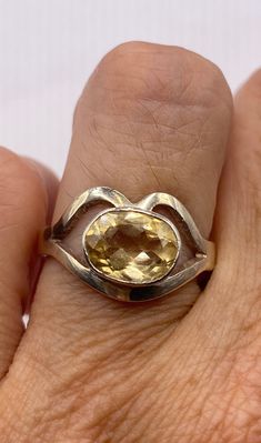 This is a lovely citrine statement ring in 925 sterling silver Size 7.5  Our jeweler can re size this for a $20 fee.  Citrine, a birthstone of November, is often the gemstone associated with the thirteenth wedding anniversary.  A citrine is a yellow to orange variety of quartz, which is a crystallized form of silica.  The yellow color results from iron trapped in the silicon matrix. The citrine draws its name from the Latin word citrina.  Citrine brings a activating energy balancing and stimulating and balancing the Solar Plexus chakra.  The Citrine signifies energy, vitality and prosperity. Citrine is a relatively hard stone rating 7 on Moh's scale. Citrine can be cleaned with mild soap in warm water, and a soft toothbrush or cloth.  Avoid harsh cleansers, bleach, chemicals other chemical 13th Anniversary Gifts, 13th Anniversary, Energy Balancing, Latin Word, Vintage Cocktail Ring, Yellow Gemstones, Citrine Ring, November Birthstone, Ring Vintage