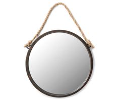 a round mirror hanging on a rope