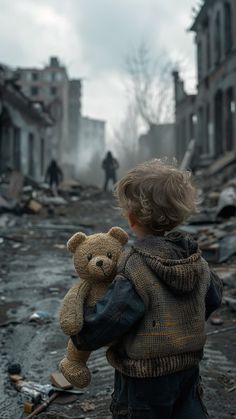 a little boy holding a teddy bear in front of an old destroyed building with people walking by