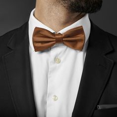 Handsome, classic brown. This staple accessory goes with just about anything. Complement earth tones or create a bold contrast with contrasting colours. Designed for the big and tall gentleman. Pre-tied and easy to wear. Formal or casual, you're good to go. Gold Champagne, Pre Tied Bow Tie, Tie Design, Champagne Color, Simple Dresses, Winter Wonderland, Bow Tie, Contrasting Colors, Champagne