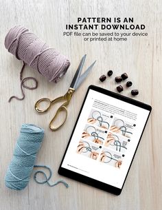 the ipad is next to yarn, scissors and knitting needles on a table with an instruction book