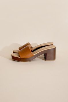 Step into style and comfort with the Lauren Slide Sandal. Crafted with vegan leather, these slide mules feature a lightweight wooden heel for a chic and effortless look. Perfect for any occasion, these sandals are sure to elevate your outfit with their unique and playful design. Fit true to size. Lauren Kate, Unique Heels, Platform Design, Mule Heels, Platform Mules, Platform Block Heels, Footwear Collection, Leather Slides, Handbag Shoes