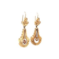 Victorian Style Diamond Earrings in Yellow Gold. These Victorian style drop yellow gold earrings are completed in 14 karat gold. The earrings feature wonderful hand engraved patterns and open work with a diamond hanging in the center. They are set with two (2) .04 carat diamonds and measure about 1.5 inches in length. Antique Yellow Gold Drop Earrings, Victorian 14k Gold Drop Earrings, Victorian Yellow Gold Earrings With Intricate Design, Victorian Yellow Gold Drop Earrings, Antique Yellow Gold Earrings For Formal Events, Antique Yellow Gold Earrings For Formal Occasions, Antique Engraved Drop Earrings, Ornate 14k Gold Earrings, Oval Yellow Gold Filigree Earrings