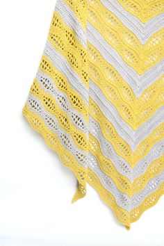 a yellow and white crocheted shawl