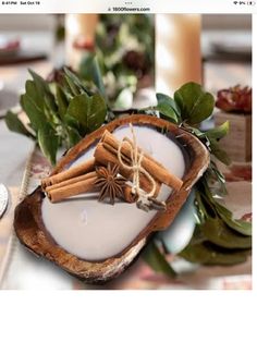 cinnamon sticks are wrapped in twine and tied with twine on top of a wooden bowl