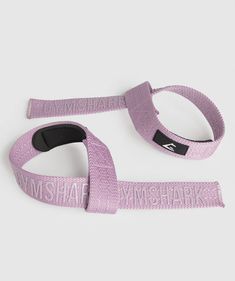 two straps with the words misshapen on them, one in purple and one in black