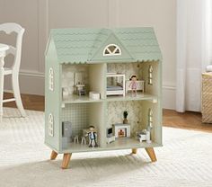 a doll house with furniture and accessories on the floor