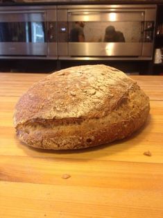 a loaf of bread sitting on top of a wooden counter