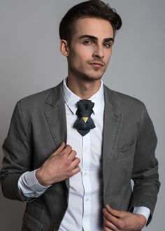 "A neck accessory - Hopper tie for men with an additional element of décor giving a neat contrast. The color palette is of reminiscence to a classic tweed with blueish-grey color tones, decorated by subtle yellow-colored threads that give a historic feel to it. A classical Hopper tie with the yellow part reminding the essential characteristic of a Ruty design - a triangle, brings a slight rebellious quality to a classical style. HOPPER TIE \"HISTORY\" Fabric rayon Care: we recommend hand-wash or Dapper Ties With Pocket Square For Black Tie Events, Elegant Bow Tie With Pocket Square As Gift, Elegant Bow Tie With Pocket Square For Formal Occasions, Dapper Bow Tie For Formal Occasions, Dapper Ties For Black-tie Events, Formal Ties With Decorative Bow For Black-tie Events, Dapper Bow Tie For Business, Dapper Bow With Ties For Formal Occasions, Dapper Formal Bow With Ties