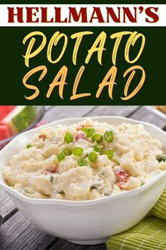 a white bowl filled with potato salad on top of a wooden table