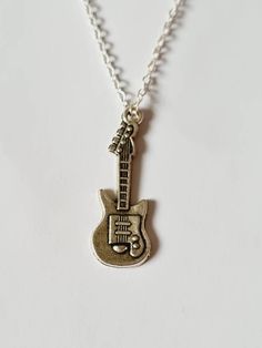 a necklace with a guitar charm on it