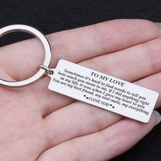 a person holding a keychain with a poem on it