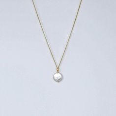 MVP's best selling necklace features a large iridescent coin pearl on a 14k gold filled rope. It's simple, striking, and makes a great gift. Materials 12-14 mm round white freshwater coin pearl with undertones of champagne, ivory and pink; 14k gold-filled chain, magnetic clasp.Size18" All jewelry is handmade by me in my Florida home studio. Orders ship free, and arrive gift wrapped and ready for giving. Please allow 1-3 business days for production. Everyday Pearl Charm Necklace, Elegant Adjustable Medallion Necklace With Coin Pendant, Elegant Coin Pendant Medallion Necklace, Elegant Adjustable Coin Pendant Medallion Necklace, Elegant Adjustable Round Medallion Necklace, Elegant Round Medallion Necklace, 14k Gold-filled Round Pearl Pendant Jewelry, Elegant White Coin Necklace With Round Pendant, Dainty Pearl Charm Round Necklace