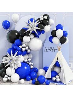 balloon arch with star and snowflake decorations in blue, white and black colors