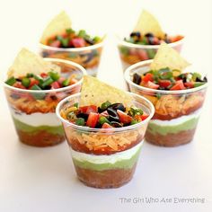 small cups filled with different types of food