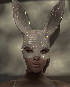 a woman wearing a bunny mask with glitters on it's ears and nose