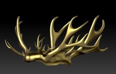 a golden deer's head with antlers on it