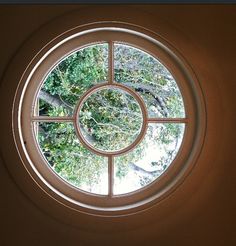 a circular window with trees in the background