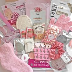 a pink gift box filled with lots of different types of gifts and items for women