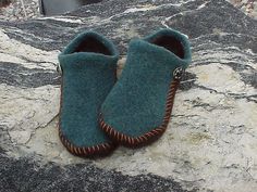 a pair of blue slippers sitting on top of a rock