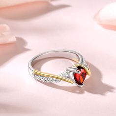 The eternity of love is transformed into a red heart-shaped main stone that blossoms on your fingertips. The golden lines wrap gently around the ring, wrapping love as gently as time. The sterling silver band is serene and elegant, carrying precious emotions. This ring is not only a gorgeous accessory, but also a testimony of love and commitment. Let it witness the best moments in your hearts and embrace the sincerity and warmth forever.Carat Weight: 2.55 ctStone Size: 7*7 mmStone Type: Jeulia® Elegant Heart Ring For Proposal On Mother's Day, Elegant Red Heart Promise Ring, Elegant Valentine's Day Gift Birthstone Ring, Red Heart Ring For Anniversary In Fine Jewelry Style, Fine Jewelry Red Heart Ring For Anniversary, Red Heart Ring For Anniversary, Fine Jewelry, Red Double Heart Jewelry For Anniversary, Red Heart Ring For Anniversary, Elegant Red Heart Ring With Gemstone