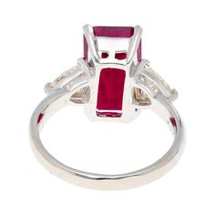 This dazzling 4.67-carat natural ruby looks stunning as the centerpiece of this ring. The ruby is emerald cut set in a classic 4-prong setting. The Platinum selected to hold this dazzling stone in place truly allows the ruby to shine. Standing to either side of the ruby are two trillion-cut diamonds, with a total weight of 0.82 carats.   Details: Item Type: Ring Metal: Platinum Size: 6.5 Weight: 5.75 Grams Setting: 4 Prong  Center Stone Details: Stone Type: Natural Ruby Carat: 4.67 Cut: Emerald Color: Red Setting: 4-Prong  Side Stones Details: Type: Natural Diamond Cut: Trillion Cut Color: White Carat: 0.82 Quantity: 2 Luxury Ruby Ring With Vvs Clarity And Emerald Cut, Red Ruby Ring With Vvs Clarity And Baguette Cut, Luxury Emerald Cut Ruby Ring With Vvs Clarity, Red Baguette Cut Ruby Ring, Gia Certified Baguette Cut Ruby Ring, Red Baguette Cut Lab-created Ruby Ring, Luxury Red Ruby Ring Baguette Cut, Luxury Ruby Ring With Emerald Cut Center Stone, Luxury Emerald Cut Ruby Ring With Center Stone