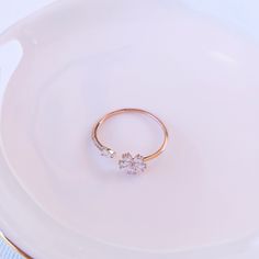 The Adjustable Floral Grace ring, made from Sterling Silver and Rose Gold-plated, offers a touch of minimalist elegance. With its slender band and understated flower design, it provides just the right amount of sparkle. Ideal for young girls or anyone seeking a hint of minimalistic jewelry. Material: Certified 925 Sterling Silver plated in Rose Gold Stone: Cubic Zirconia Size: adjustable - best fits sizes 4, 5, 6, 7 Promise Rose Gold Midi Rings With Simple Design, Rose Gold Midi Rings With Simple Design For Promise, Simple Rose Gold Diamond Ring, Delicate Rose Gold Flower Ring For Promise, Delicate Rose Gold Midi Rings For Promise, Delicate Rose Gold Flower Promise Ring, Minimalist Rose Gold Promise Flower Ring, Minimalist Rose Gold Flower Ring For Anniversary, Rose Gold Simple Midi Rings