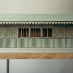 a model of a building with shutters and windows