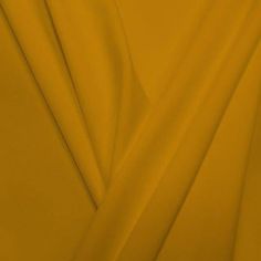 A pleated piece of performance nylon spandex fabric in the color medallion yellow. Blue Moo, Fashion Content, Vintage Dollhouse, Athleisure Fashion, Border Print, 4 Way Stretch Fabric, Sequin Fabric, Cotton Lights, Blue Moon