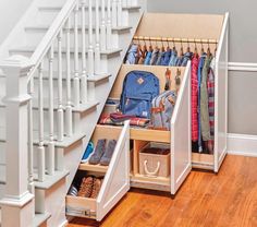 an under the stairs storage area with shoes and bags