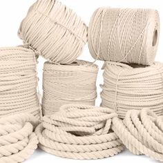 several white rope spools are stacked on top of each other