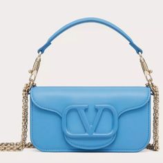 Blue Valentino Garavani Crossbody Bag Designer Light Blue Shoulder Bag With Detachable Strap, Designer Light Blue Bag With Detachable Strap, Designer Light Blue Bags With Detachable Strap, Designer Light Blue Top Handle Shoulder Bag, Luxury Blue Crossbody Shoulder Bag, Blue Top Handle Shoulder Bag For Evening, Designer Light Blue Bag With Detachable Handle, Luxury Light Blue Bag With Detachable Strap, Luxury Blue Shoulder Bag For Shopping