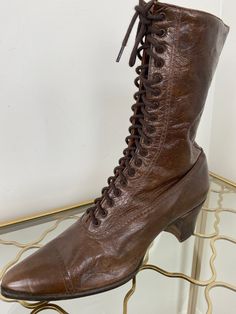 Classic dark brown leather lace up granny boots. Pristine condition! Please see further details below. Label - AHM System Made in Canada Leather with stacked heel Labelled as size 6. Should fit a size 5.5 or a narrow size 6 but please refer to measurements below as I am unable to offer returns. Please remember these are vintage and may be slightly narrower than today's sizing standards.  2" heel 10" tall  Widest part of exterior sole is approximately 3"  Exterior sole length 10.5 " approximately Granny Boots, Victorian Lace, Vintage Boots, Lace Up Ankle Boots, Dark Brown Leather, Leather Lace, Vintage Lace, Stacked Heel, Brown Boots