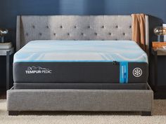 the tempur - pedic mattress is on display in a room with blue walls