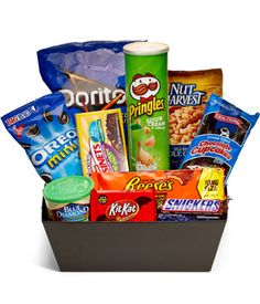 the snack box is filled with snacks, candy, and other things to eat in it