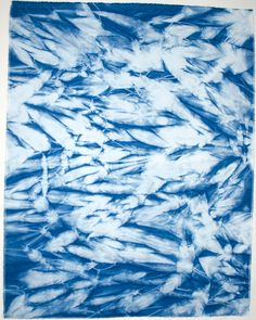 a blue and white painting with lots of fish in it